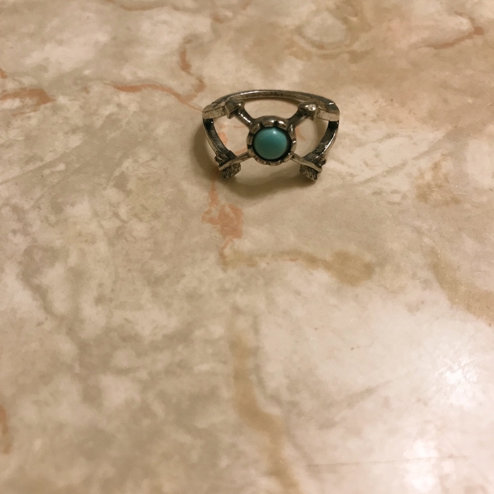 Size five ring with turquoise bead and bow and arrow design on the side